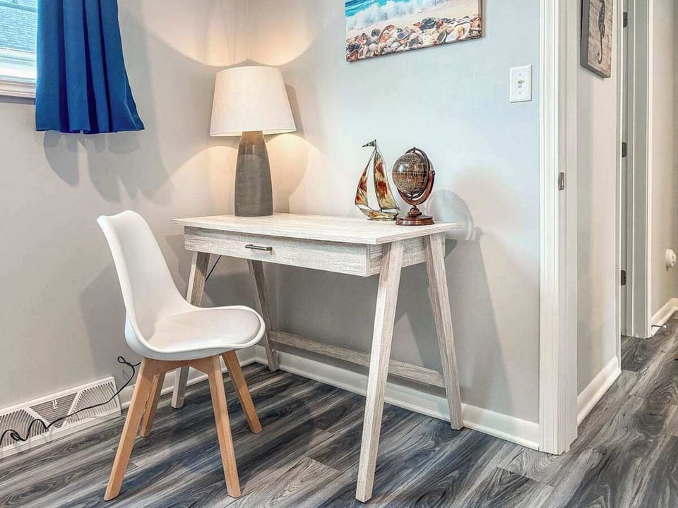 A dedicated workspace with a comfortable chair and desk, perfect for remote work, planning your beach day, or catching up on emails during your stay.
