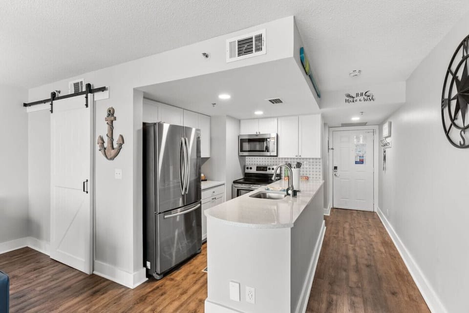 Modern kitchen with stainless appliances and a large island perfect for cooking and gathering.