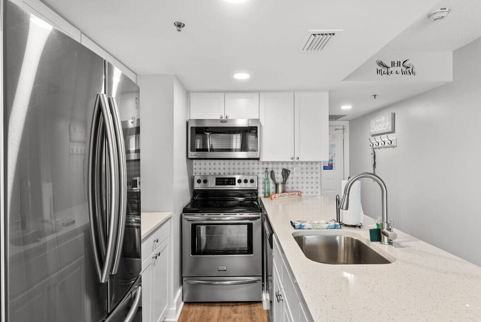 Fully-stocked kitchen with sleek countertops and everything you need for home-cooked meals.