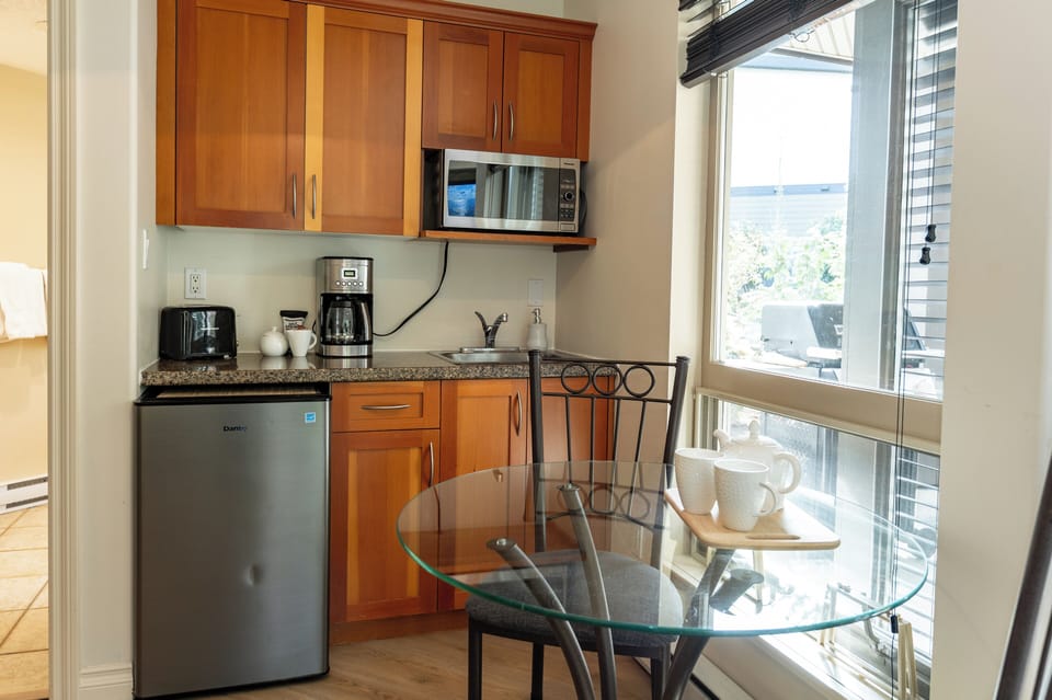 Stocked Kitchenette. Opens to living room area. Tons of  natural light.