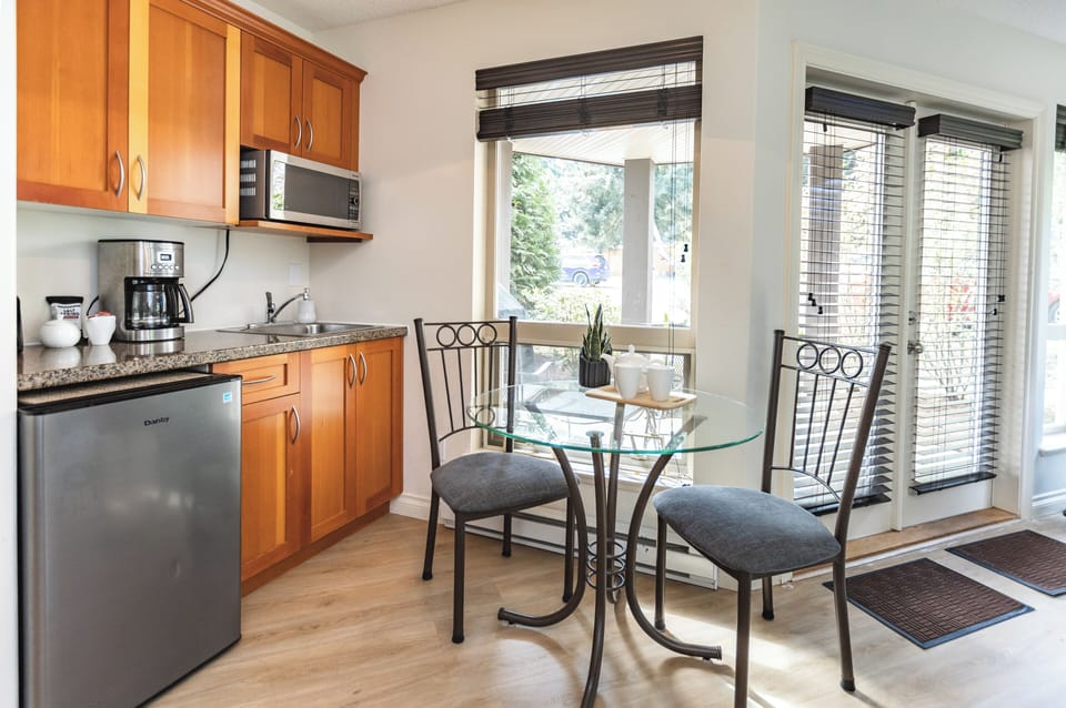 Enjoy a cup of coffee. Stocked Kitchenette. Open Concept into Living room.