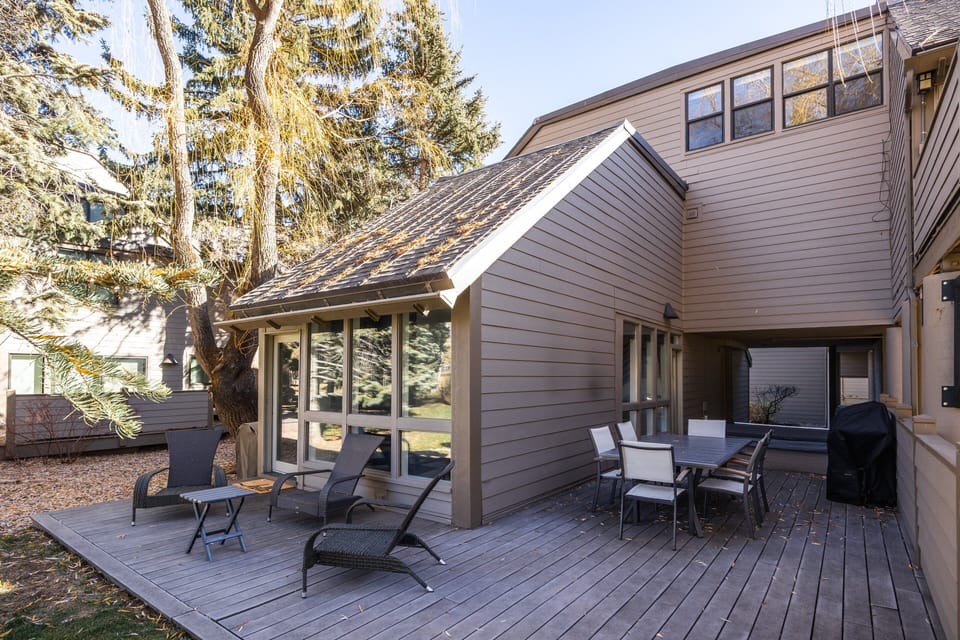 Spacious private deck with outdoor seating and dining area—perfect for morning coffee, fresh mountain air, or relaxing after a day of adventure.