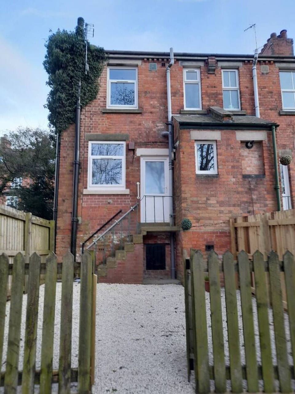 Entrance at the rear of the house with fenced garden