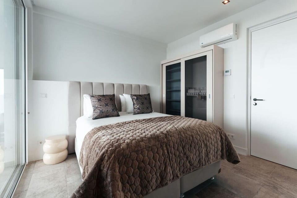 Second Bedroom | The second bedroom features a King size bed, TV and a bathroom with private vanity & shower, with a separate toilet in the hallway, ensuring a comfortable and relaxing stay for all guests.