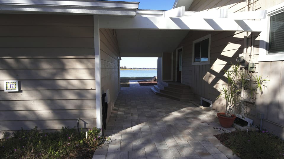 Enter through the breezeway with spectacular lake views & 120ft of lake footage.
