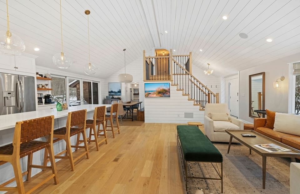 Open sightlines from kitchen to lounges make hosting seamless.