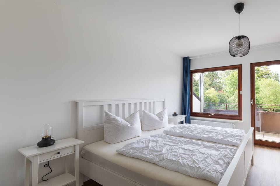 Bedroom with double bed and balcony