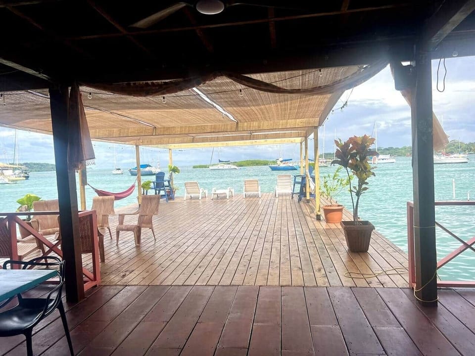 Lower deck with hammocks, chairs, games, and sun shades.