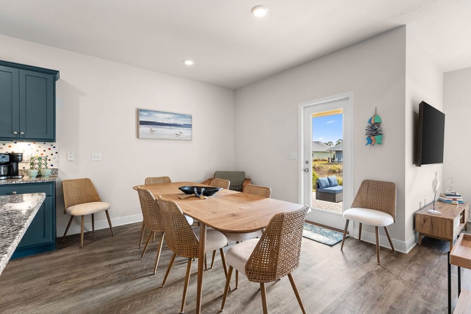 Gather around your stylish dining table where warm wood meets modern comfort, perfect for morning coffee or evening meals together.