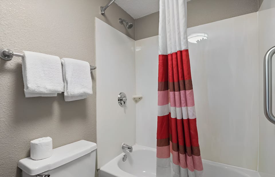 Rinse off and relax with a clean tub‑shower combo.