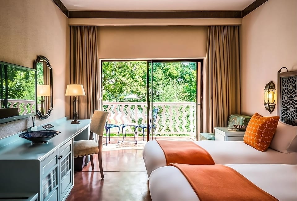 Sip morning coffee as greenery frames your balcony retreat.