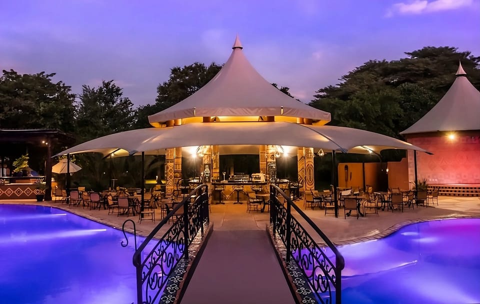 Unwind at dusk as the pool glows beside the pavilion.