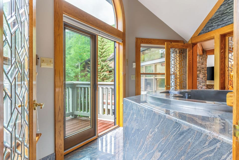 Hot Tub, Main Level - Indoor, stainless steel hot tub that can be accessed through the primary bedroom or the kitchen