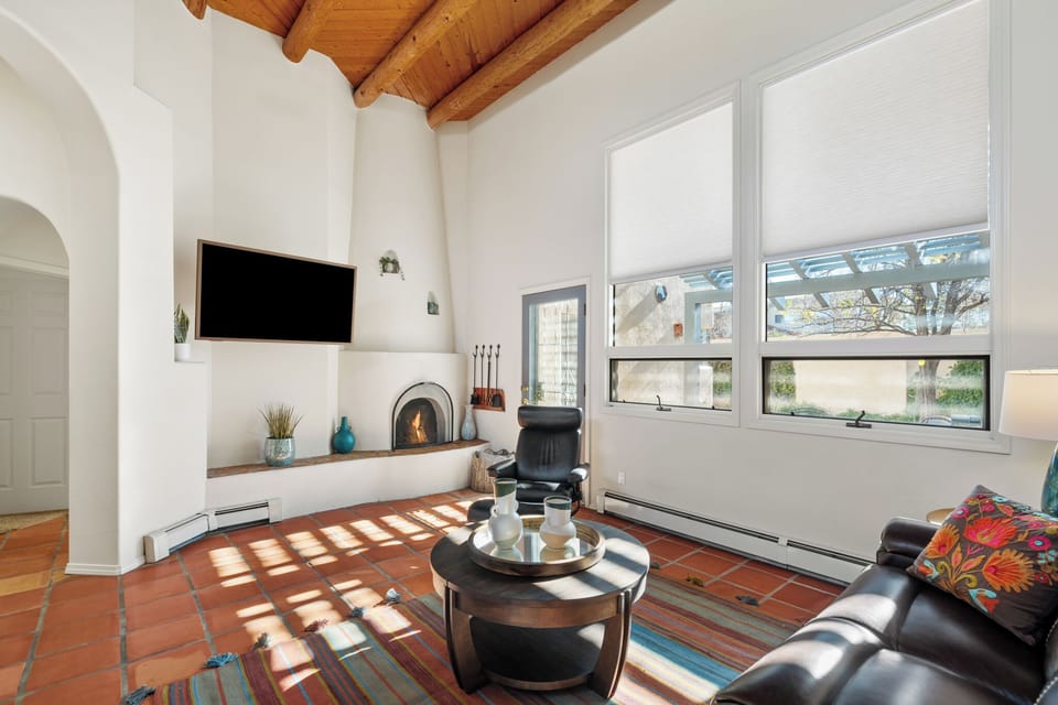 living room featuring rustic wood beams, a cozy fireplace, and comfortable seating where you can unwind after exploring the area.