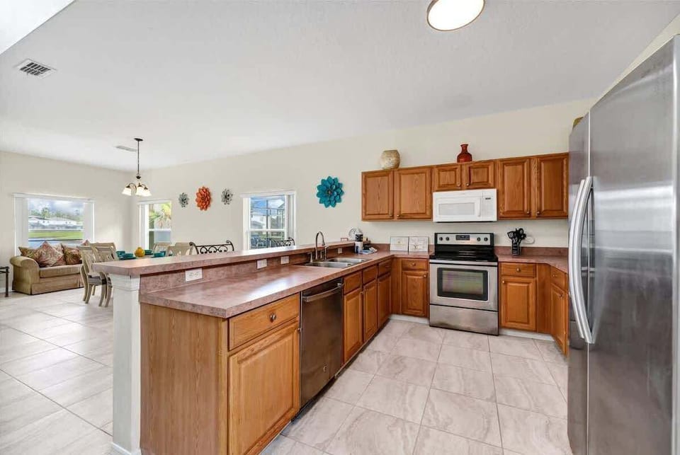 Fully equipped kitchen with stainless-steel appliances and everything needed for home-cooked meals.