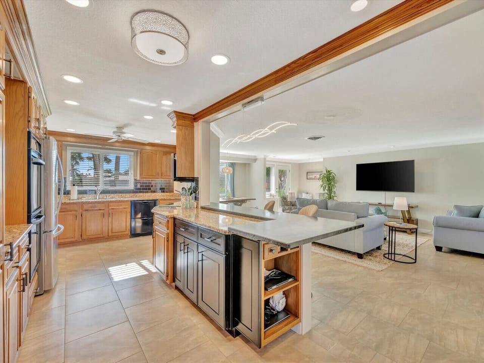 Fully Stocked Open Kitchen and Comfortable Family Room Layout