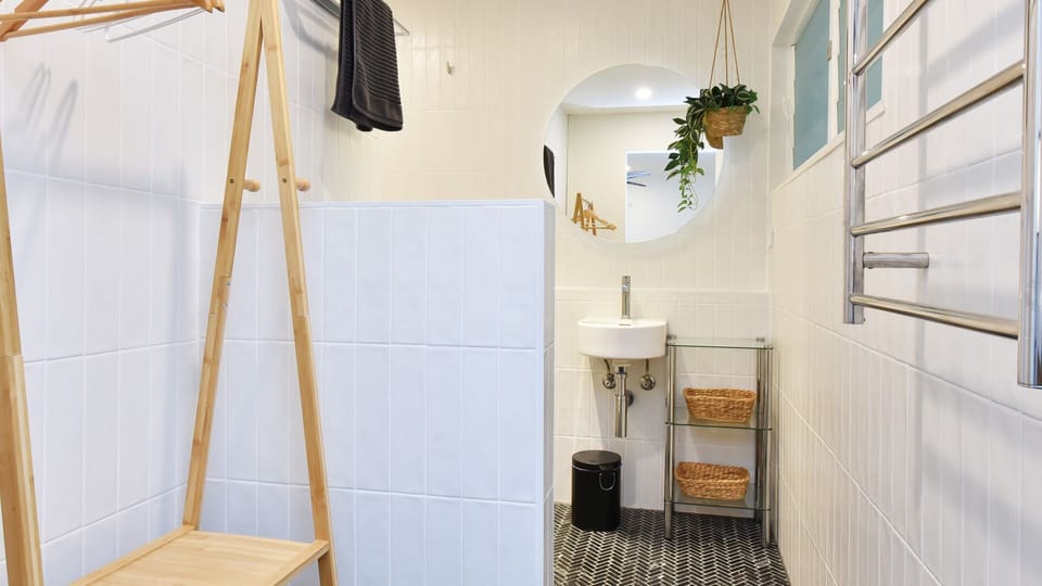 Minimalist bathroom with walk-in shower and natural touches