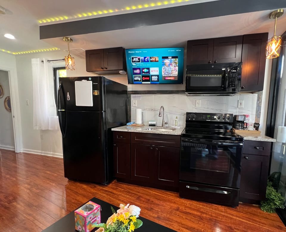 fully remodeled kitchen with full size fridged & large TV