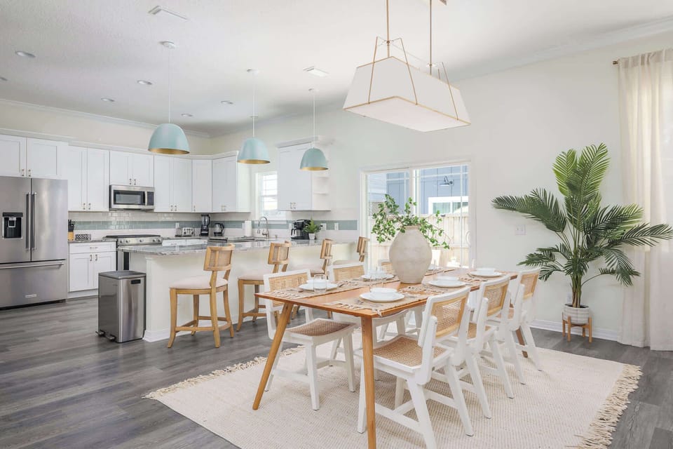 "Host gatherings in this wide kitchen and dining space with quartz island, stainless appliances and seating for six. Cooking and conversation flow easily here. - The Coquina - St. Augustine, FL"