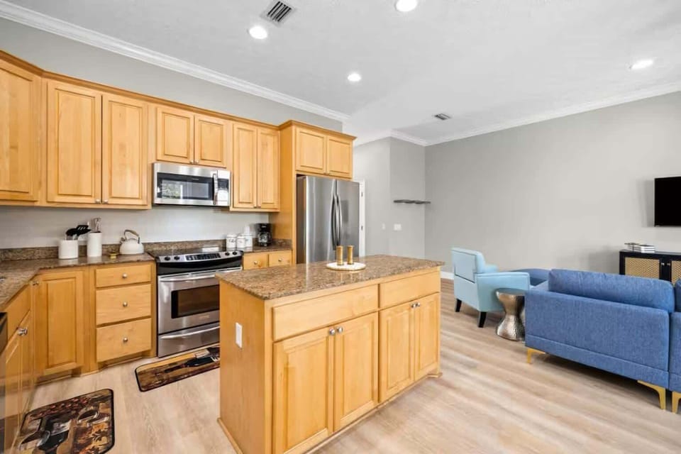 Spacious kitchen with granite counters, modern appliances, and coffee po