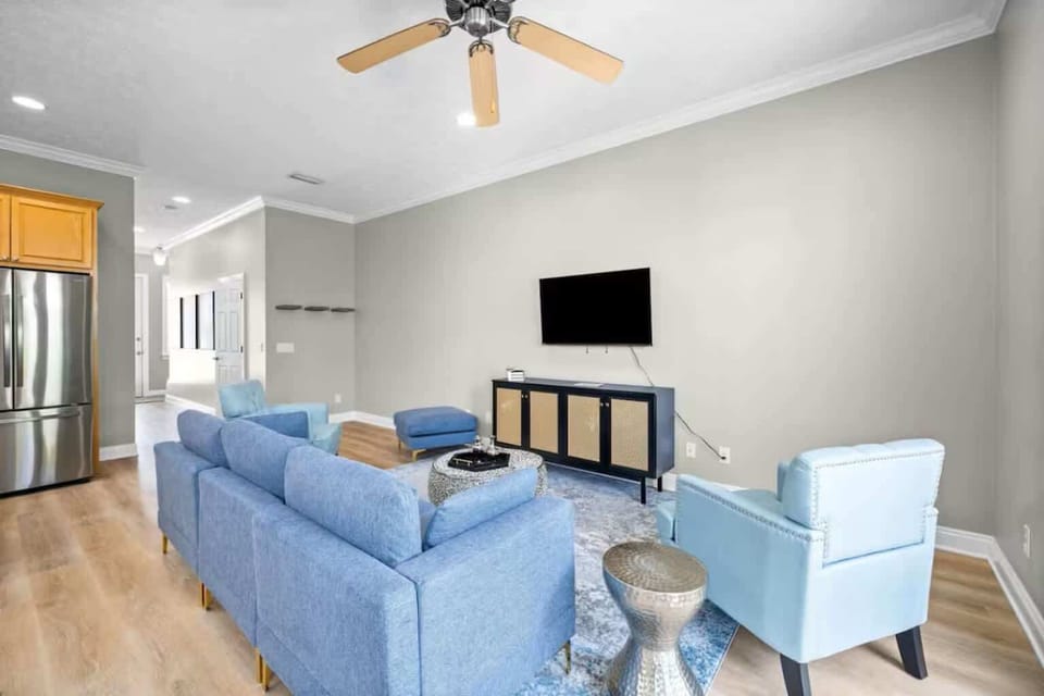 Inviting living room with vibrant blue furniture and relaxing open layout