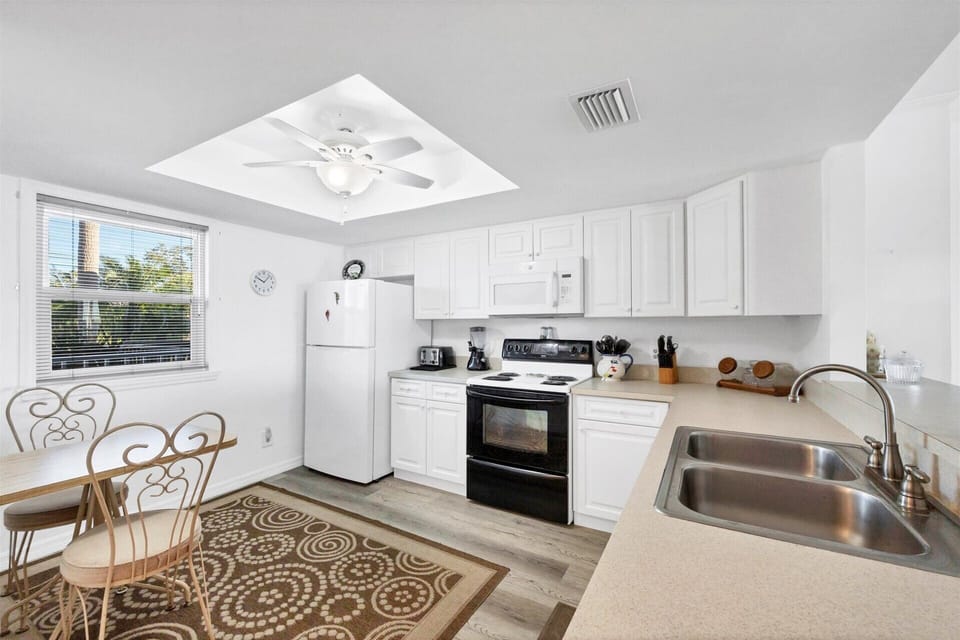 Fully-equipped kitchen overlooking dining and living room areas