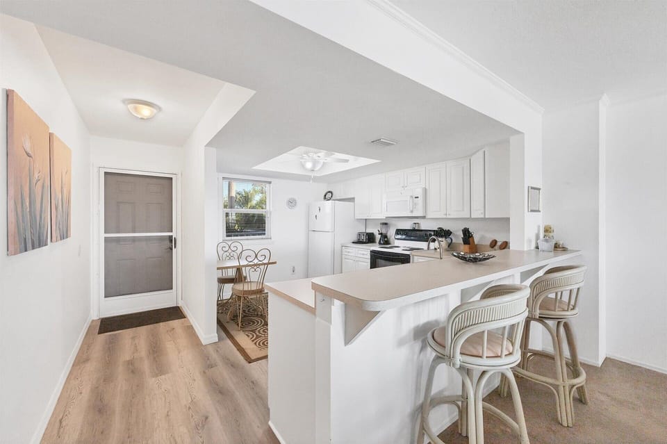 Fully-equipped kitchen overlooking dining and living room areas
