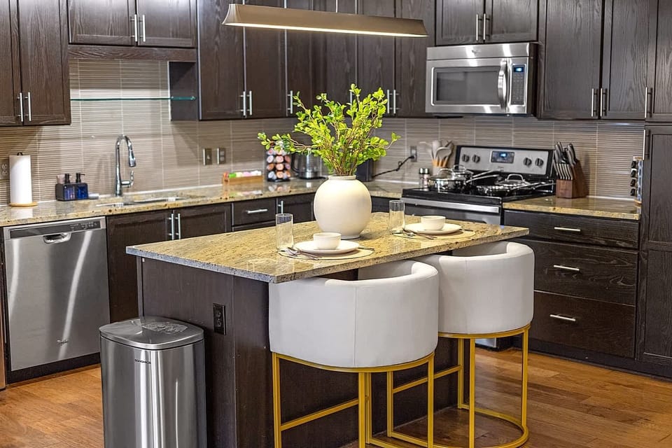Stylish dining area with elegant place settings, granite counters, and natural light that makes every meal feel special.