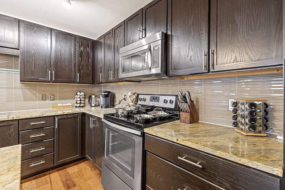 Contemporary kitchen with ample storage, polished appliances, and generous counter space. A clean and functional area for preparing meals.