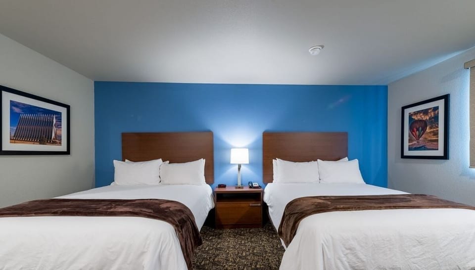 Sleep soundly between two inviting beds under warm lighting.