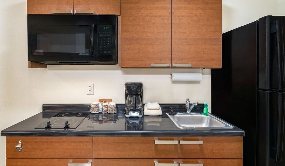 Cook with ease in a kitchenette featuring fridge and microwave.