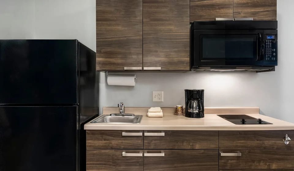 Settle in with a sleek kitchenette for easy meals.