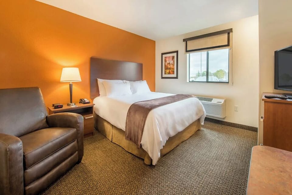 Unwind in crisp linens with warm lighting and easy comfort.