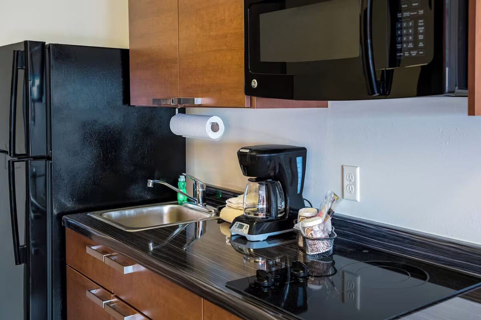 Enjoy convenient cooking with full fridge, microwave, and sink.