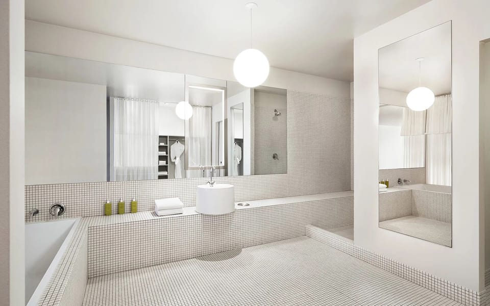 Enjoy an airy, oversized bathroom with bright, calming light