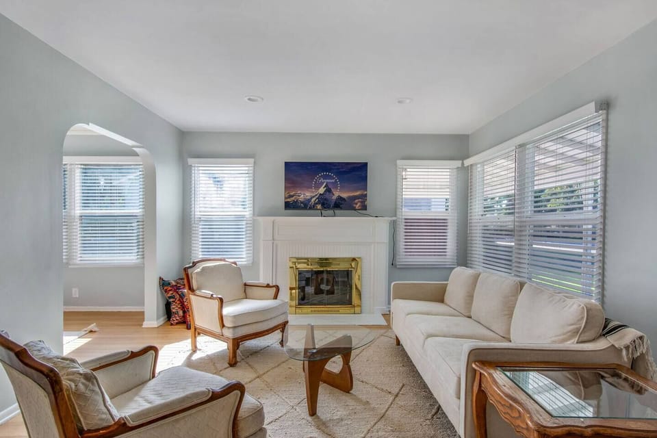 Comfortable living room with plush seating, fireplace, and Smart TV for streaming.