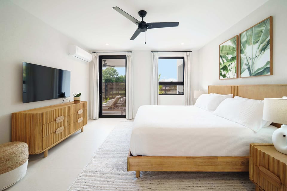  This stunning 2-bedroom, 2-bathroom villa offers the perfect blend of modern design and island elegance—just a 3-minute walk from the serene Reeds Bay Beach!