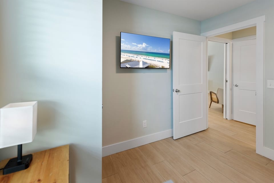 Unwind in your bright living space with a large TV displaying beautiful beach scenes, perfect for movie nights after exploring.