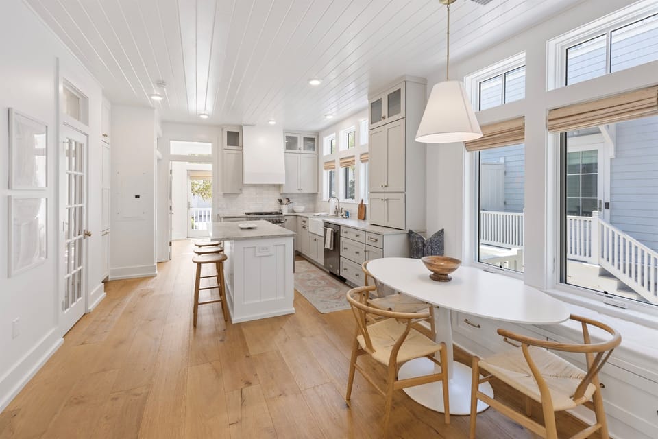 Cook and dine in your bright, coastal-inspired kitchen with gleaming quartz counters, professional appliances, and charming breakfast nook.