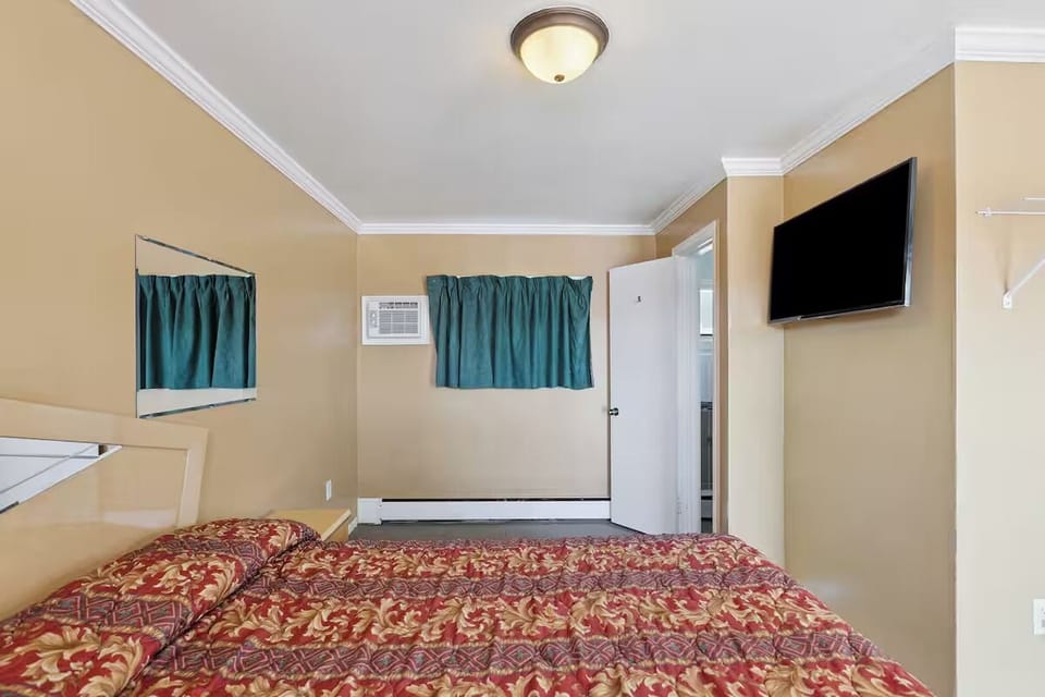 Unwind in bed with wall-mounted TV for easy nights.