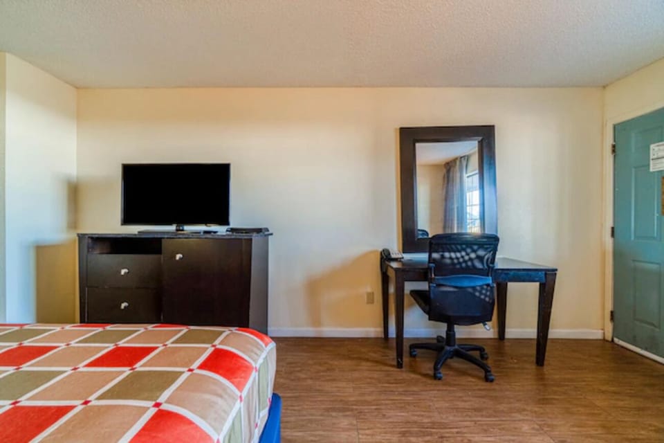 Enjoy a simple setup with TV, desk, and space.