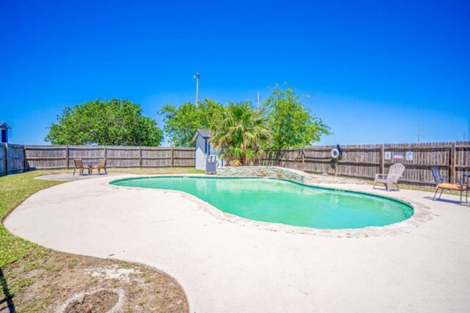 Float and relax in the calm pool under clear skies.