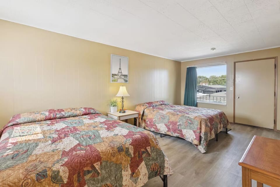 Sink into cozy double beds in a sunlit, restful room.