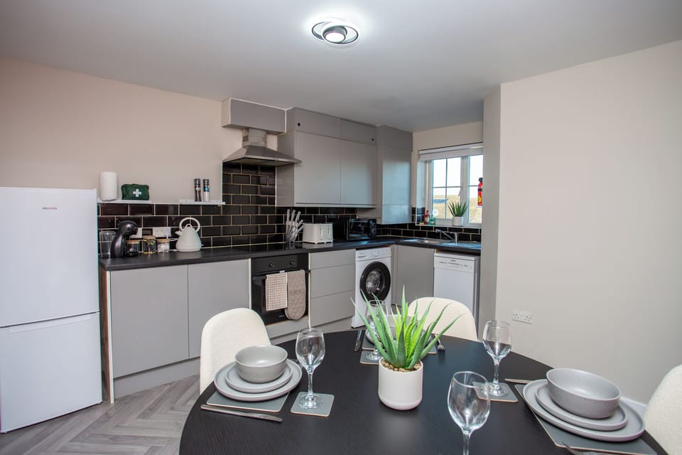 Fully equipped kitchen with sleek finishes and everything you need to cook at home