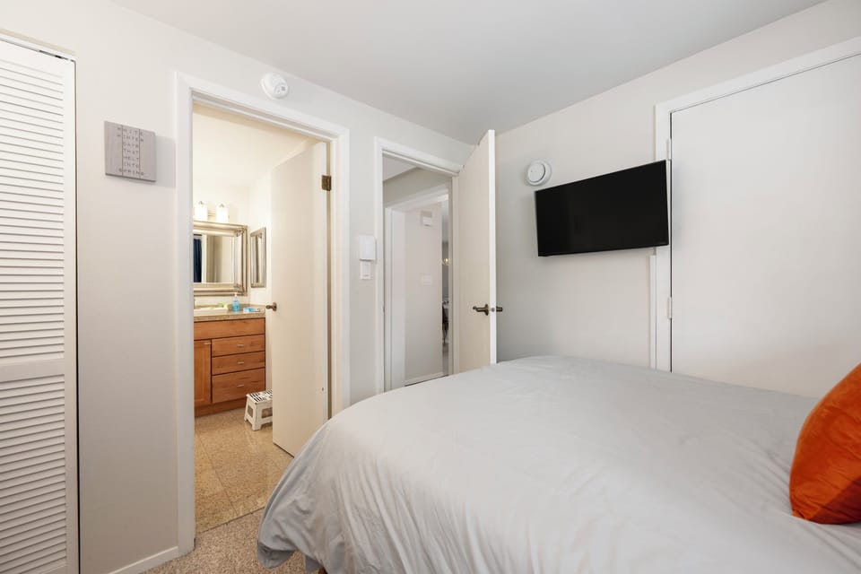 Unwind in your peaceful bedroom with wall-mounted TV and convenient en-suite access for ultimate comfort.