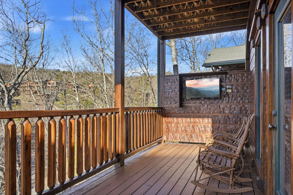 Covered deck w/ rocking chairs, TV, & porch swing