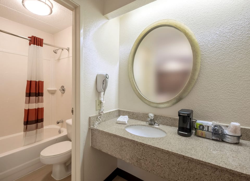 Refresh easily with a clean vanity and bright bath setup.
