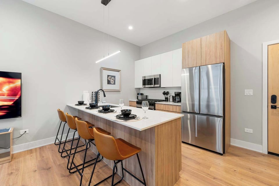 Open kitchen island w warm wood accents, perfect for casual meals or morning coffee.