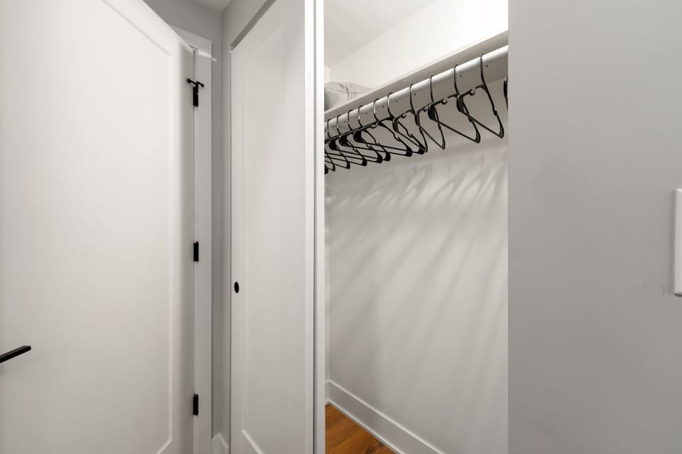 Open closet space w shelving and hanging room to keep outfits organized.