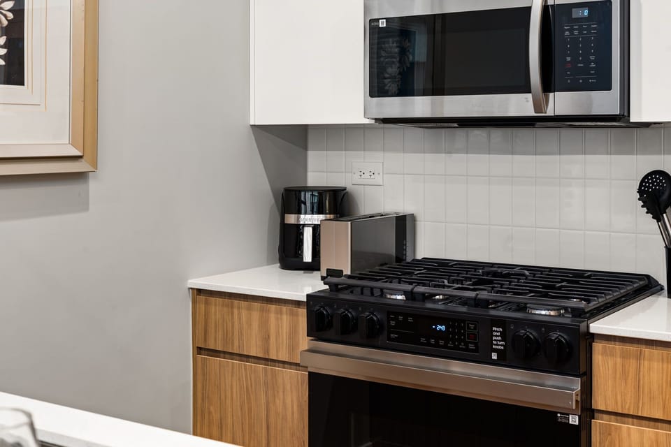 Modern oven and range framed by clean cabinetry for simple, efficient meals.